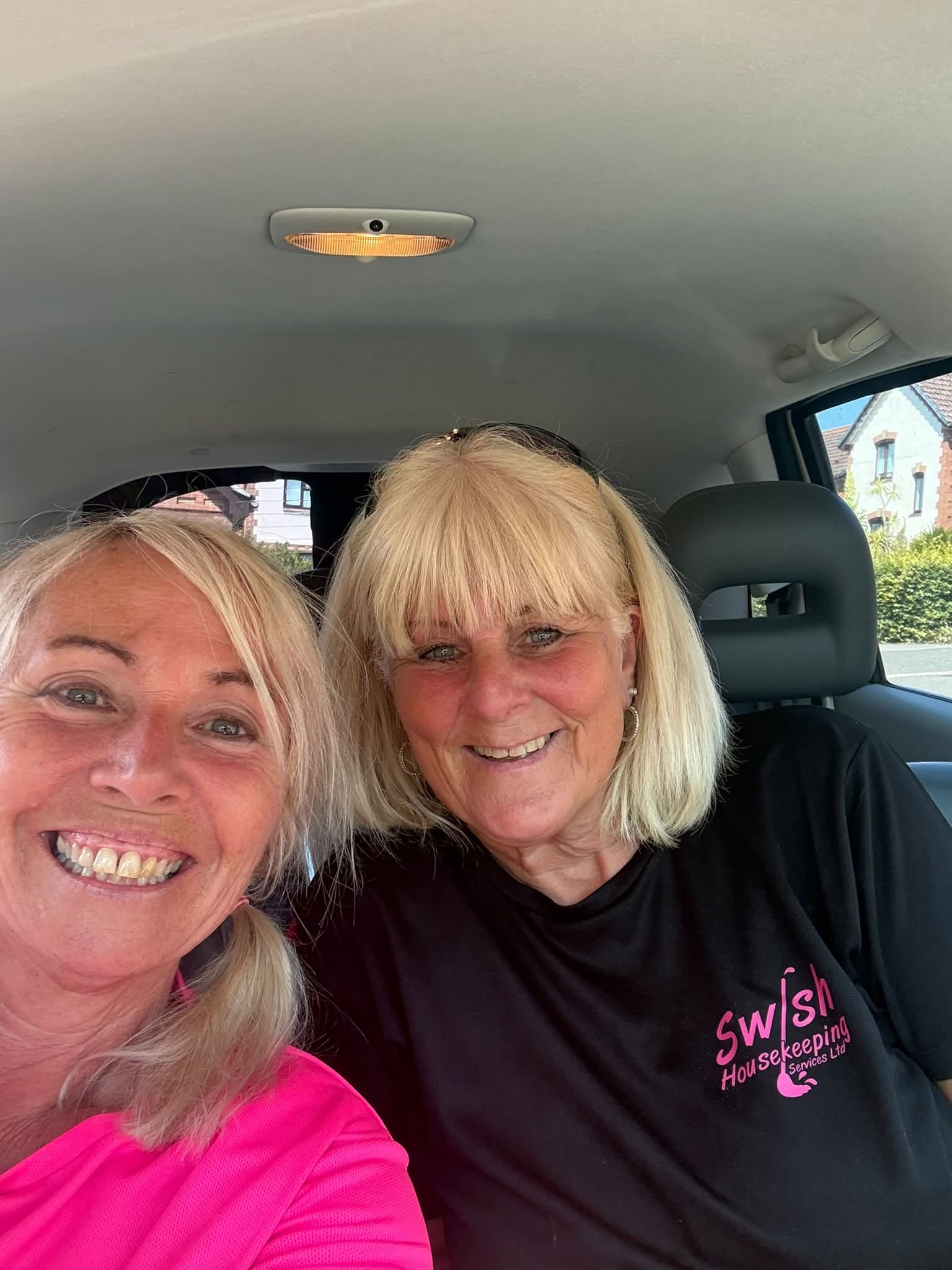 Two Swish Housekeeping team members smiling together
