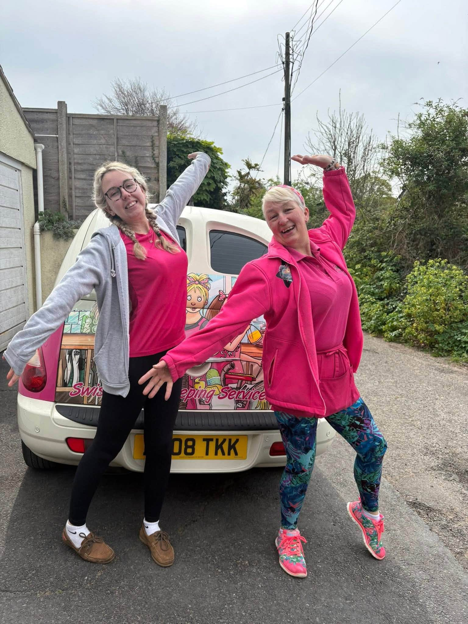 Two Swish Housekeeping team members smiling beside the Swish van